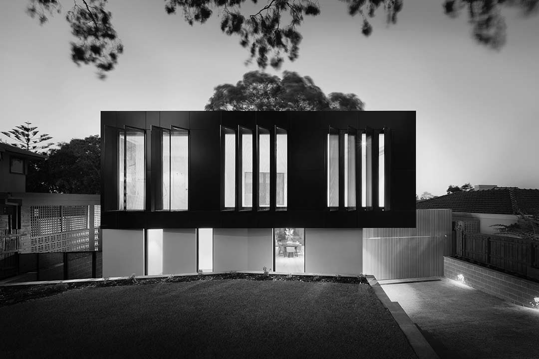 black and white image of modern designed house with square facade