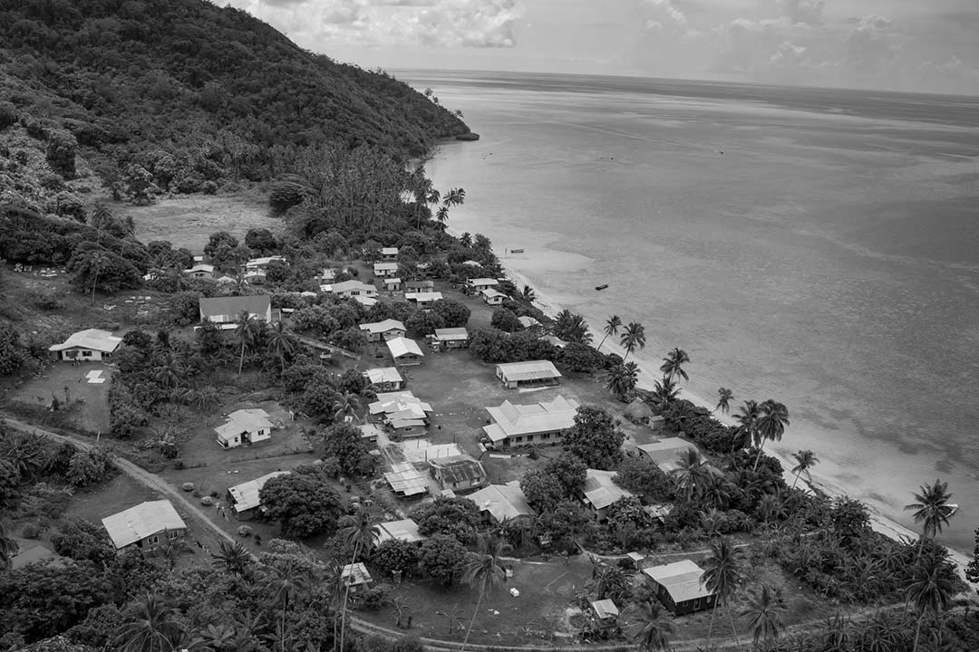 black and white image of a small beachside community with small rundown homes
