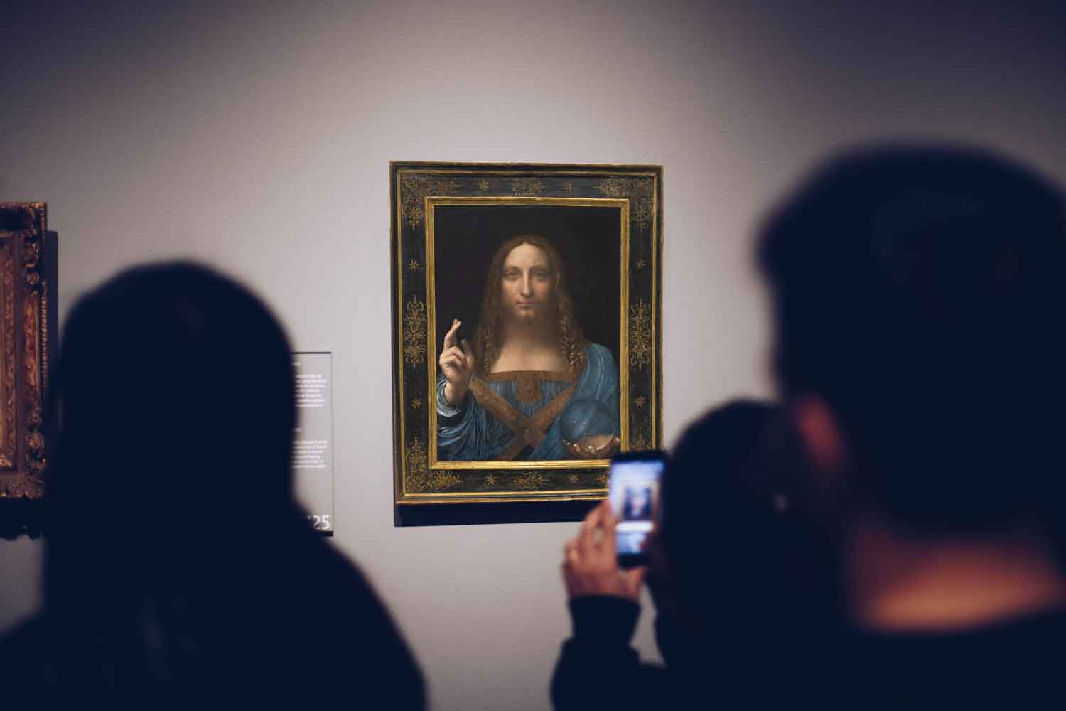 people gathered around photographying a lost painting from leonardo davinci