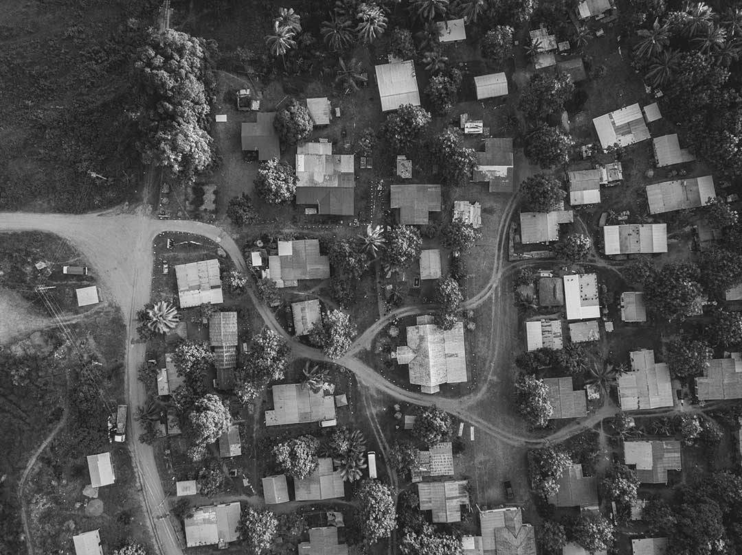 black and white aerial photo of a busy network of homes 