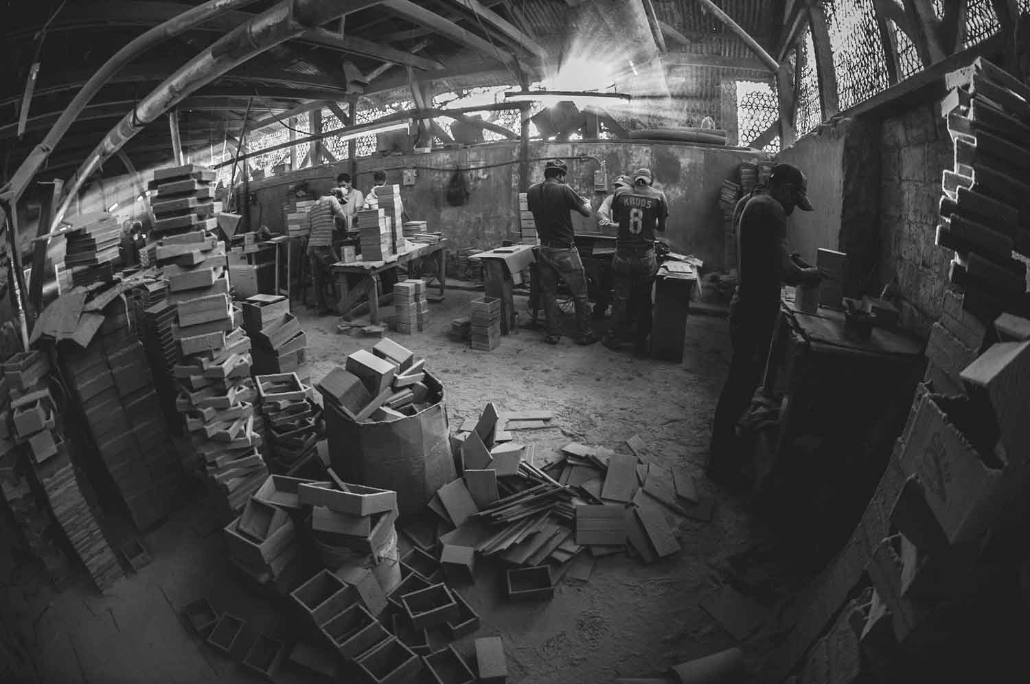 black and white image of a dirty busy factory