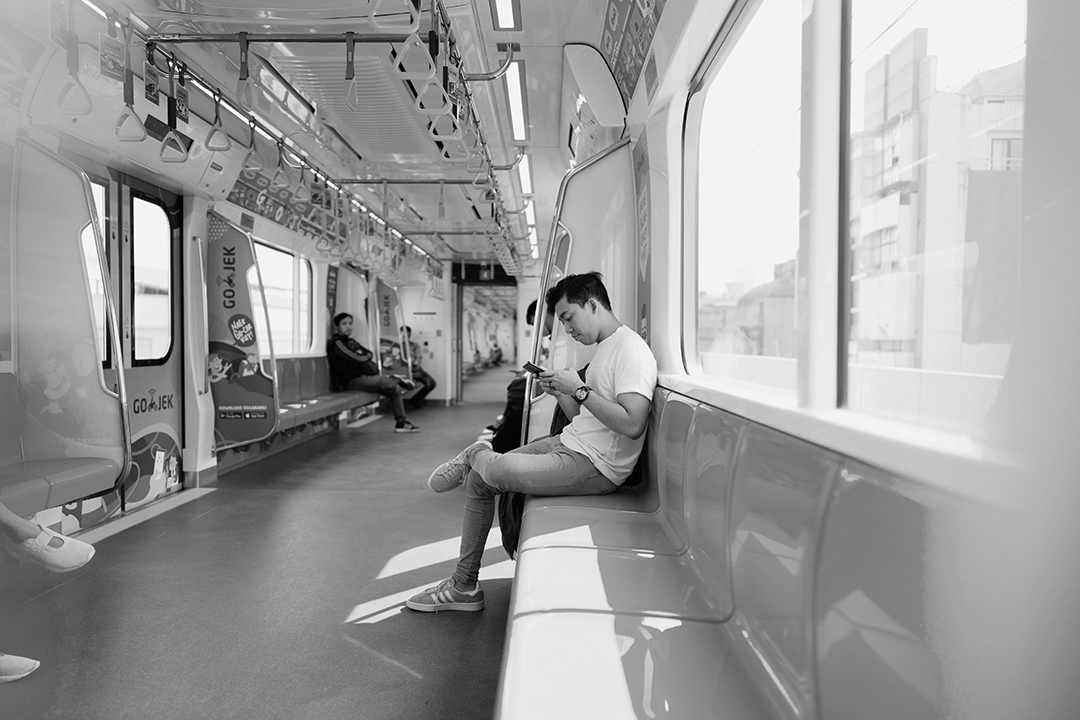black and white image of samroze sitting in a train