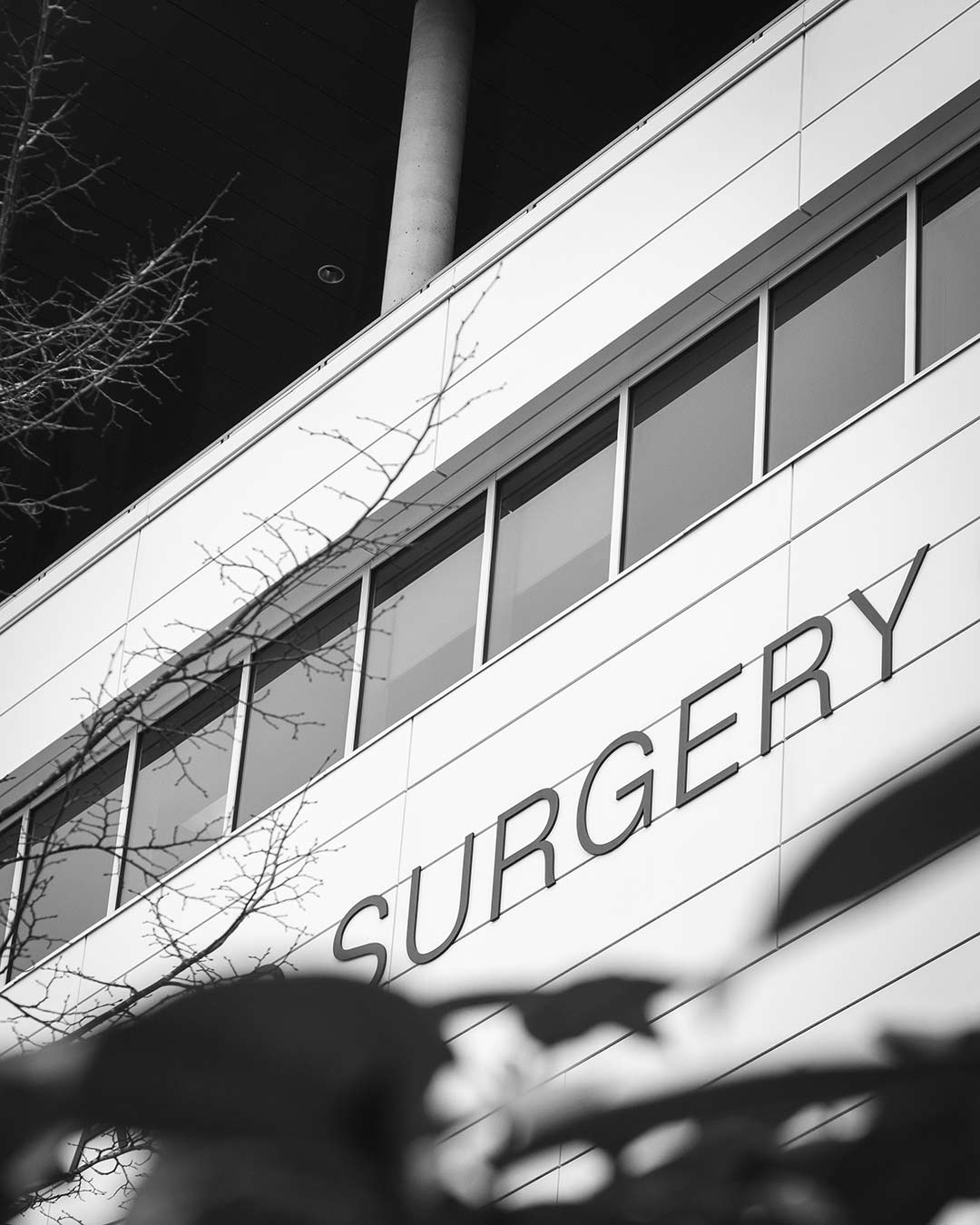 black and white image of a hospital building with 'surgery' on the side